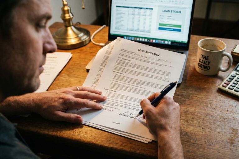 Borrower reviewing APR disclosure laws and loan agreement documents before signing