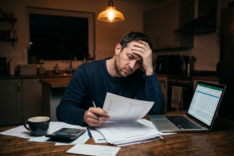 Stressed borrower reviewing installment loan documents highlighting costly mistakes