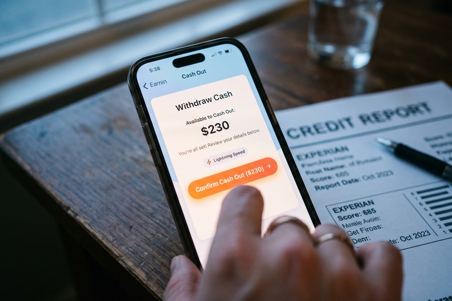 A secured credit card and credit-builder loan side by side representing the stacked credit-building approach for rideshare drivers
